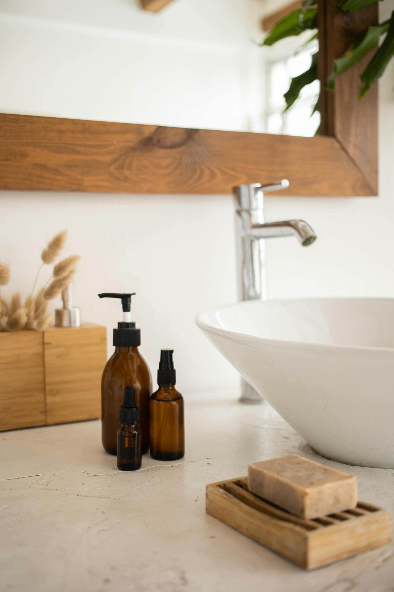 Bathroom shelf with hyaluronic acid serums and moisturisers arranged in a clean minimal aesthetic