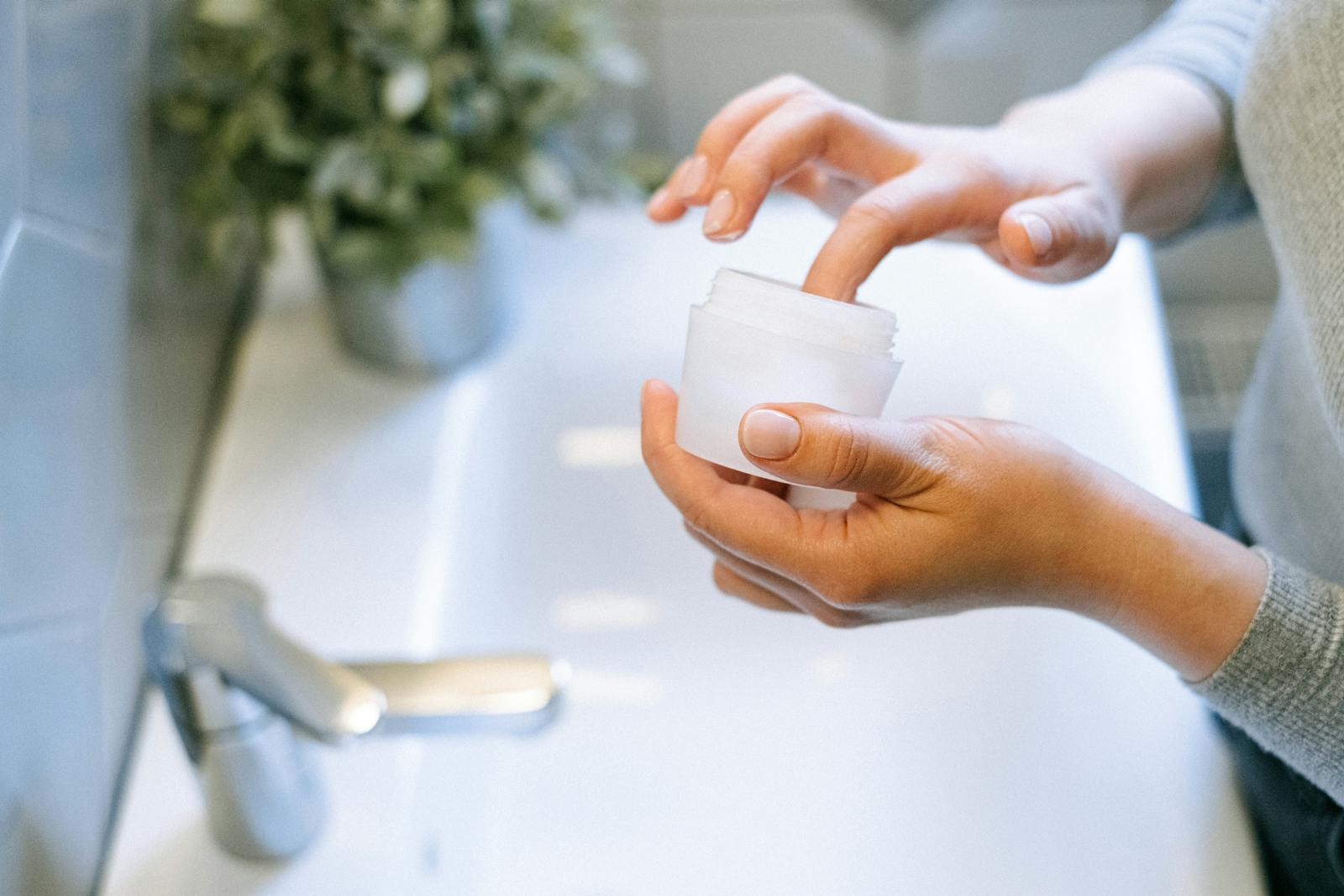 Hands applying a peptide cream as part of an evening anti-ageing skincare routine
