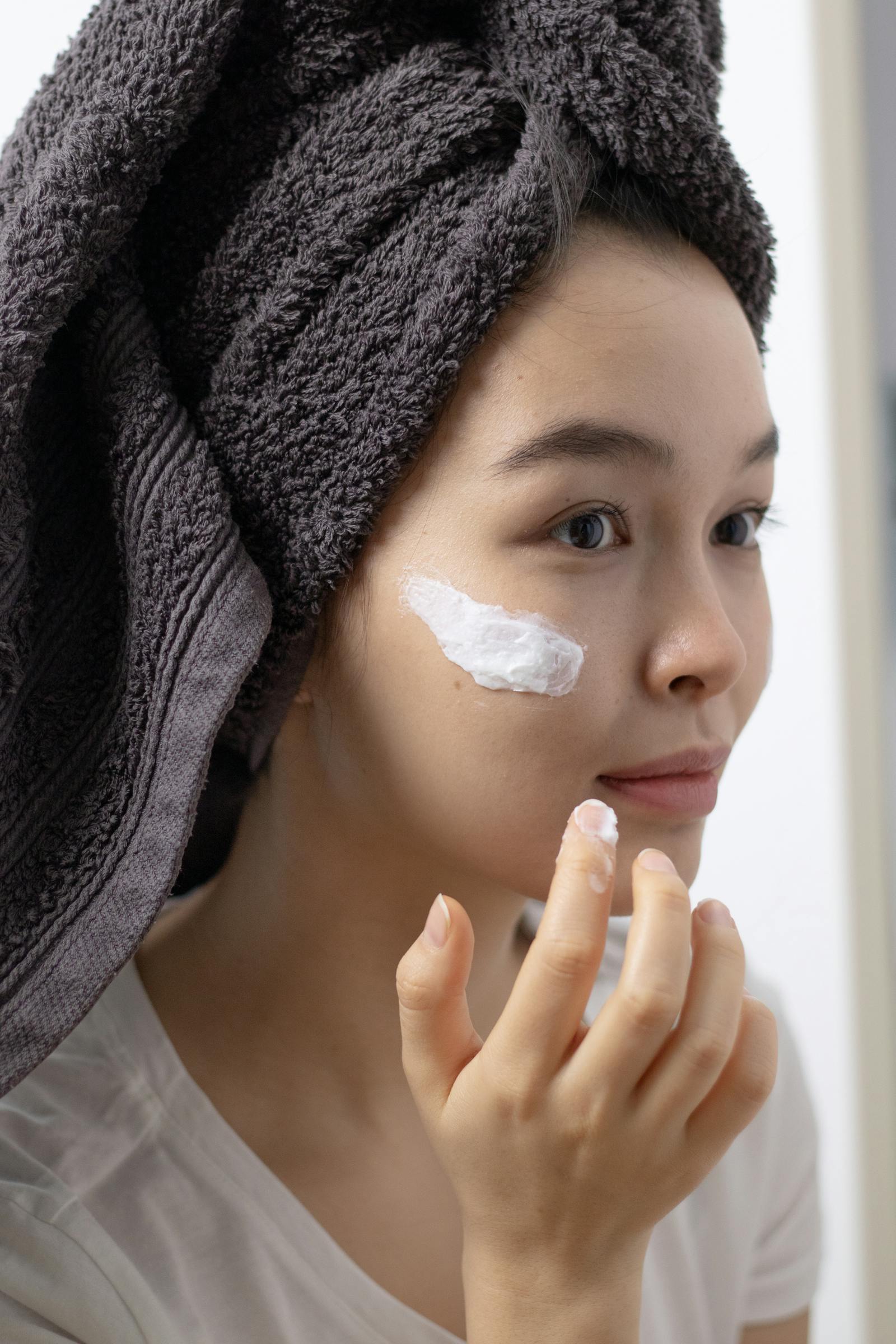 Close-up of hands gently applying a ceramide-rich cream during a barrier repair routine