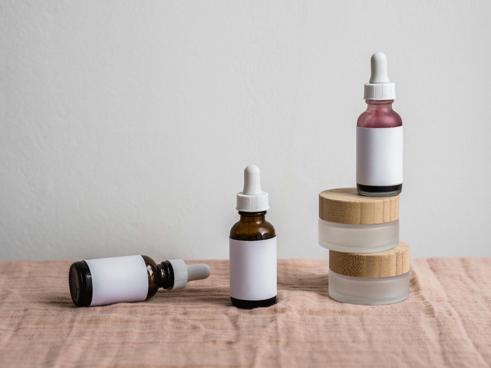 Minimalist dropper bottles on linen representing the expanded 2026 EU INCI glossary entries