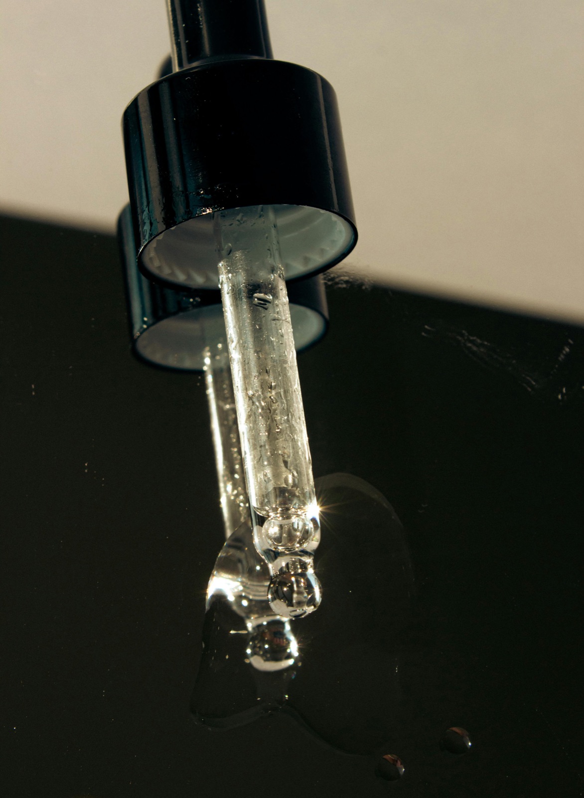Glass dropper bottle of a brightening tranexamic acid serum on a clean neutral background